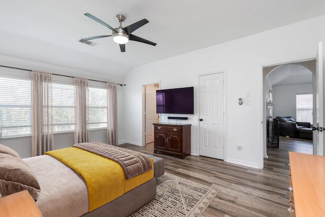 20930 Morgan Knoll Ln, Katy, TX 77449 - bedroom featuring lofted ceiling, arched walkways, wood finished floors, multiple windows, and ceiling fan