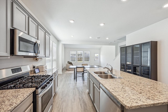 7227 Songlark Landing Ct, Katy, TX 77493 - kitchen with appliances with stainless steel finishes, plenty of natural light, gray cabinets, and recessed lighting