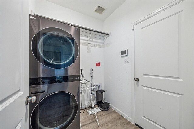 7227 Songlark Landing Ct, Katy, TX 77493 - washroom featuring stacked washer / drying machine and wood finished floors