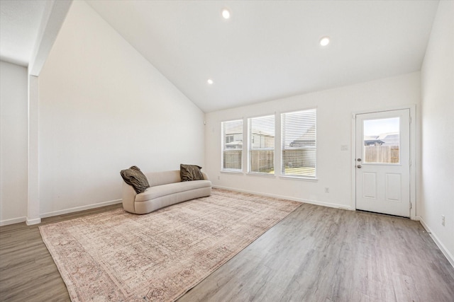 7227 Songlark Landing Ct, Katy, TX 77493 - living area with wood finished floors, lofted ceiling, and recessed lighting