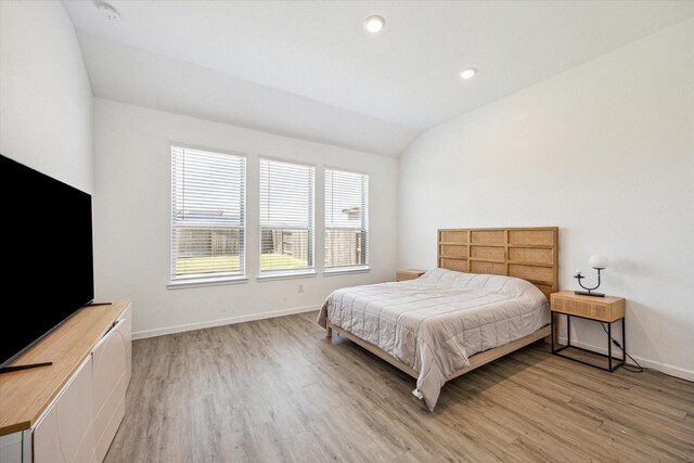 7227 Songlark Landing Ct, Katy, TX 77493 - bedroom with light wood-style flooring, lofted ceiling, and recessed lighting