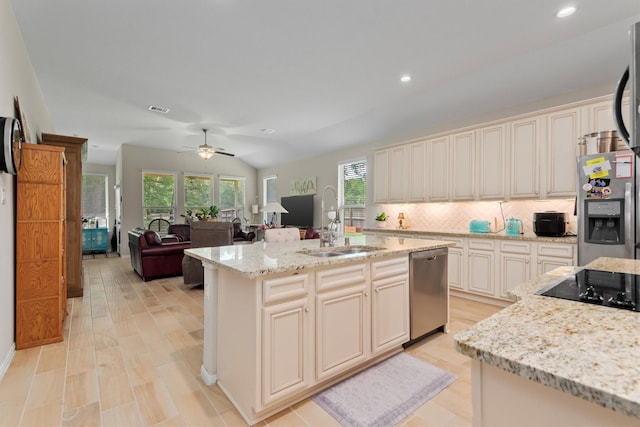 9171 White Tail Dr, Conroe, TX 77303 - kitchen with stainless steel appliances, plenty of natural light, tasteful backsplash, light stone countertops, and recessed lighting