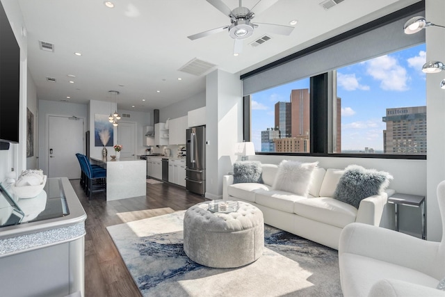 1211 Caroline St Unit 1504, Houston, TX 77002 - living area featuring dark wood-style floors, ceiling fan, a city view, and recessed lighting