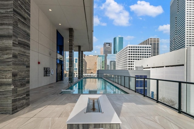 1211 Caroline St Unit 1504, Houston, TX 77002 - community pool featuring a view of skyline and a patio area