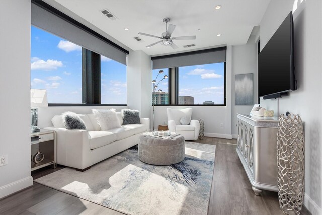 1211 Caroline St Unit 1504, Houston, TX 77002 - living area featuring ceiling fan, wood finished floors, plenty of natural light, and recessed lighting
