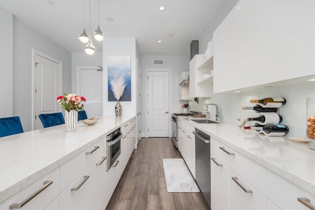 1211 Caroline St Unit 1504, Houston, TX 77002 - kitchen with modern cabinets, appliances with stainless steel finishes, white cabinetry, and recessed lighting