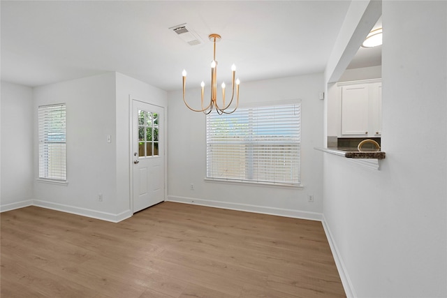 206 Delaney St, Houston, TX 77009 - unfurnished dining area with light wood-type flooring and a chandelier