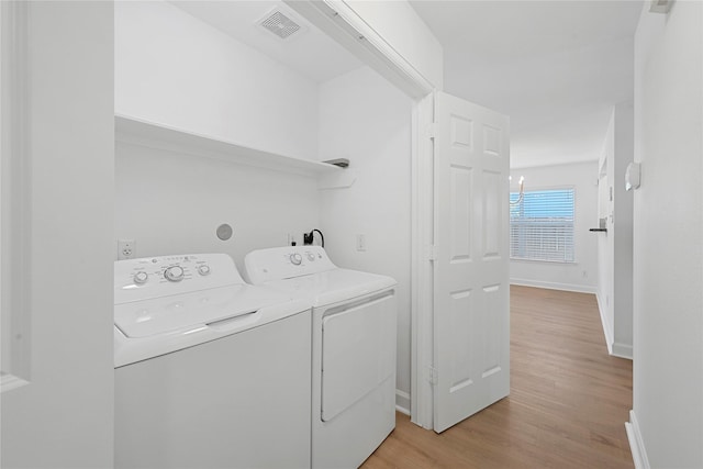 206 Delaney St, Houston, TX 77009 - laundry area with washing machine and dryer and light wood-style flooring