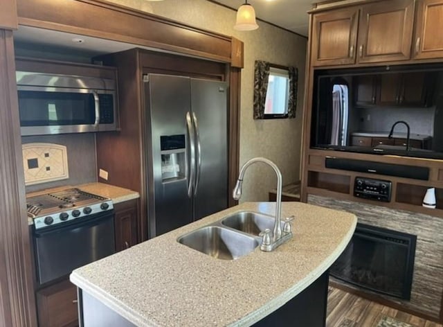 103 Dogfish, Palacios, TX 77465 - kitchen with appliances with stainless steel finishes, a kitchen island with sink, and dark wood finished floors