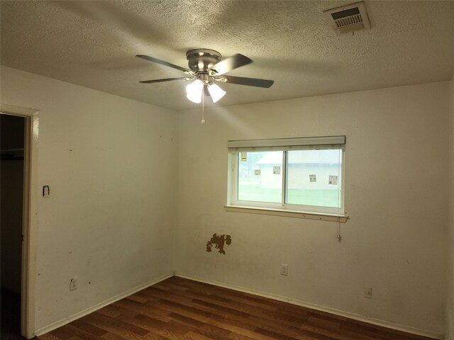 6410 Barrygate Dr, Spring, TX 77373 - unfurnished room featuring dark wood-style flooring, ceiling fan, and a textured ceiling