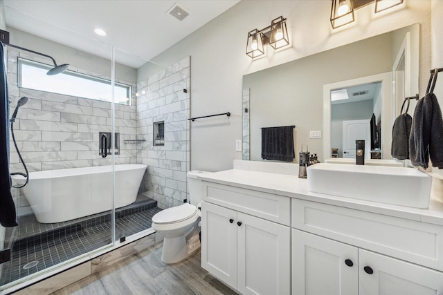 6730 Knox St Unit A, Houston, TX 77091 - bathroom featuring vanity, a soaking tub, a shower stall, and wood finished floors