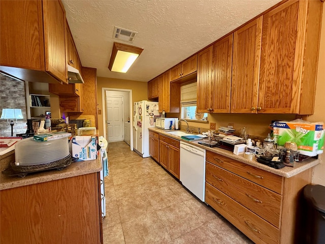 501 S Travis St, Deer Park, TX 77536 - kitchen featuring white appliances and brown cabinetry