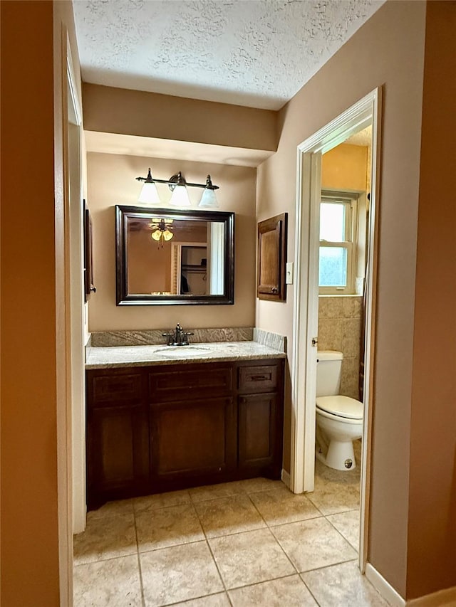 501 S Travis St, Deer Park, TX 77536 - bathroom featuring vanity, tile patterned flooring, and a textured ceiling