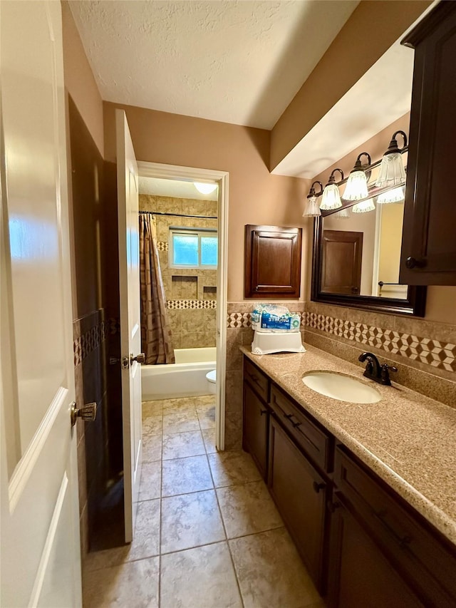 501 S Travis St, Deer Park, TX 77536 - bathroom featuring vanity, shower / tub combo, a textured ceiling, and tile walls