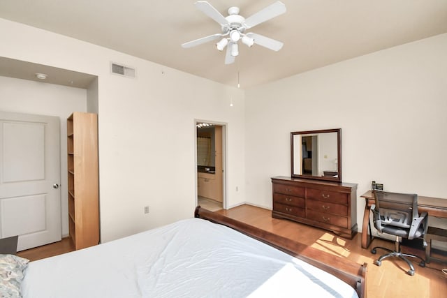3505 Sage Rd Unit 2910, Houston, TX 77056 - bedroom featuring wood finished floors, an office area, a ceiling fan, and connected bathroom
