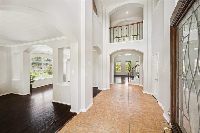 2332 Shadow Falls Ln, Pearland, TX 77584 - foyer entrance featuring crown molding, arched walkways, and tile patterned floors