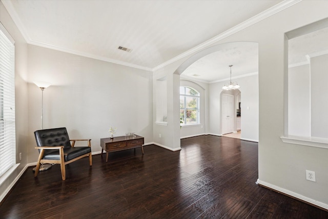 2332 Shadow Falls Ln, Pearland, TX 77584 - living area with arched walkways, hardwood / wood-style floors, ornamental molding, and a chandelier