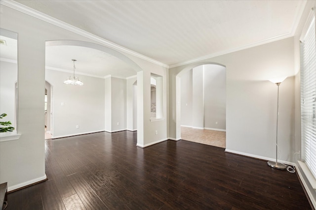 2332 Shadow Falls Ln, Pearland, TX 77584 - spare room with arched walkways, wood-type flooring, ornamental molding, and a chandelier