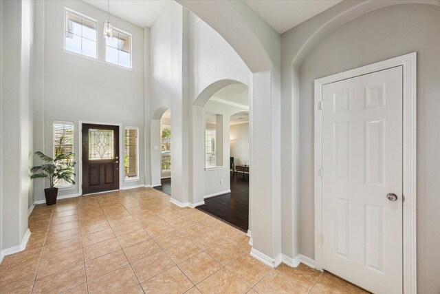 2332 Shadow Falls Ln, Pearland, TX 77584 - entryway with arched walkways, light tile patterned floors, and plenty of natural light