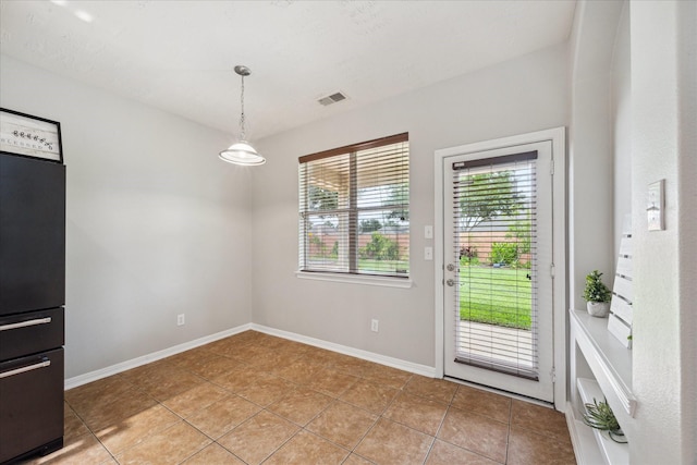 2332 Shadow Falls Ln, Pearland, TX 77584 - unfurnished dining area with light tile patterned floors and baseboards