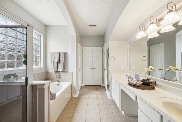2332 Shadow Falls Ln, Pearland, TX 77584 - bathroom with double vanity, tile patterned flooring, plenty of natural light, and a bath