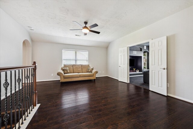 2332 Shadow Falls Ln, Pearland, TX 77584 - living area with ceiling fan, a textured ceiling, arched walkways, and hardwood / wood-style flooring