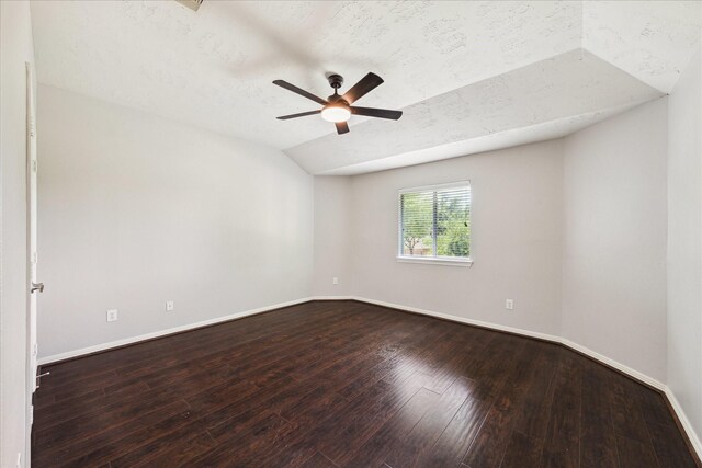 2332 Shadow Falls Ln, Pearland, TX 77584 - spare room featuring lofted ceiling, ceiling fan, dark wood-type flooring, and a textured ceiling