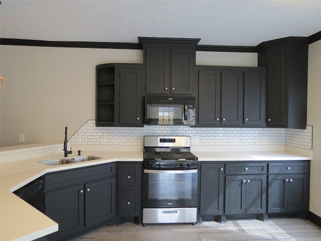 11918 Sagedowne Ln, Houston, TX 77089 - kitchen featuring stainless steel range with gas cooktop, black microwave, open shelves, light wood-type flooring, and light countertops