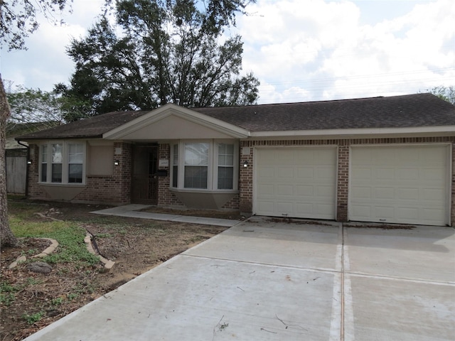 11918 Sagedowne Ln, Houston, TX 77089 - ranch-style house with brick siding, a garage, concrete driveway, and a shingled roof