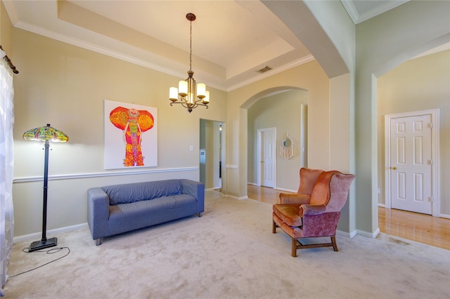 23742 Indian Hills Way, Katy, TX 77494 - living area with arched walkways, carpet floors, ornamental molding, a chandelier, and a raised ceiling