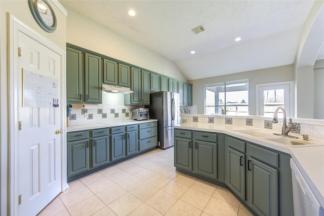 23742 Indian Hills Way, Katy, TX 77494 - kitchen featuring freestanding refrigerator, dishwasher, decorative backsplash, light countertops, and under cabinet range hood
