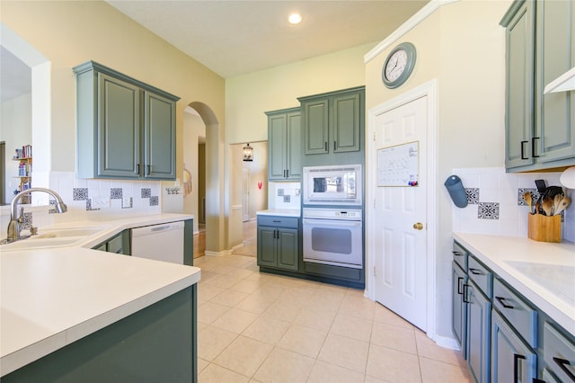 23742 Indian Hills Way, Katy, TX 77494 - kitchen with white appliances, arched walkways, decorative backsplash, and light countertops