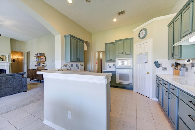 23742 Indian Hills Way, Katy, TX 77494 - kitchen with white appliances, open floor plan, arched walkways, light tile patterned flooring, and a peninsula