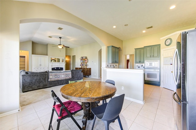 23742 Indian Hills Way, Katy, TX 77494 - dining space featuring arched walkways, a ceiling fan, lofted ceiling, light tile patterned floors, and recessed lighting