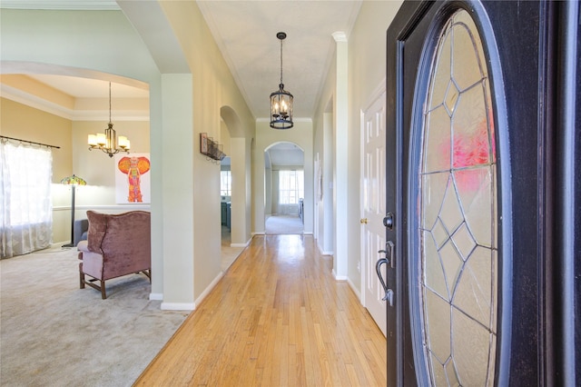 23742 Indian Hills Way, Katy, TX 77494 - entryway with arched walkways, a chandelier, crown molding, and light wood-type flooring
