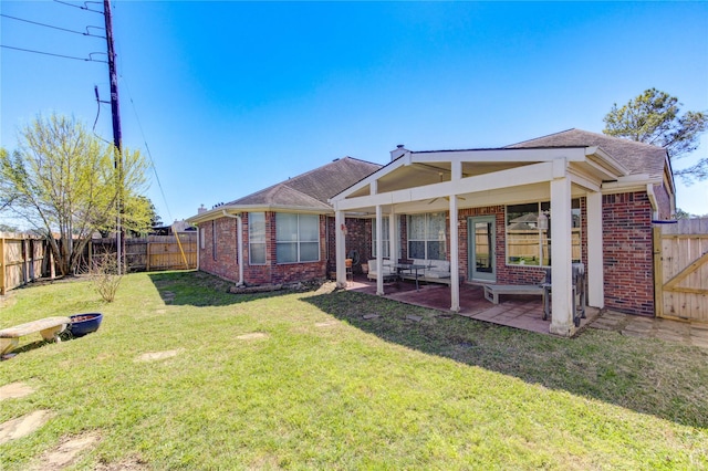 23742 Indian Hills Way, Katy, TX 77494 - back of property featuring brick siding, a fenced backyard, a patio area, and a shingled roof