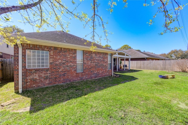 23742 Indian Hills Way, Katy, TX 77494 - back of property featuring a fenced backyard, brick siding, and roof with shingles
