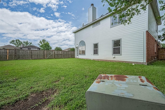 1811 Elm Shadow Dr, Missouri City, TX 77489 - back of property with brick siding, a fenced backyard, and a chimney