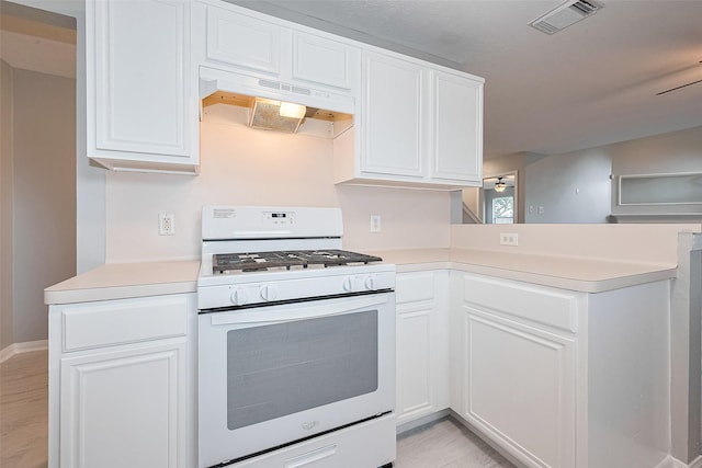 1811 Elm Shadow Dr, Missouri City, TX 77489 - kitchen featuring white range with gas stovetop, under cabinet range hood, light countertops, white cabinets, and light wood-style flooring