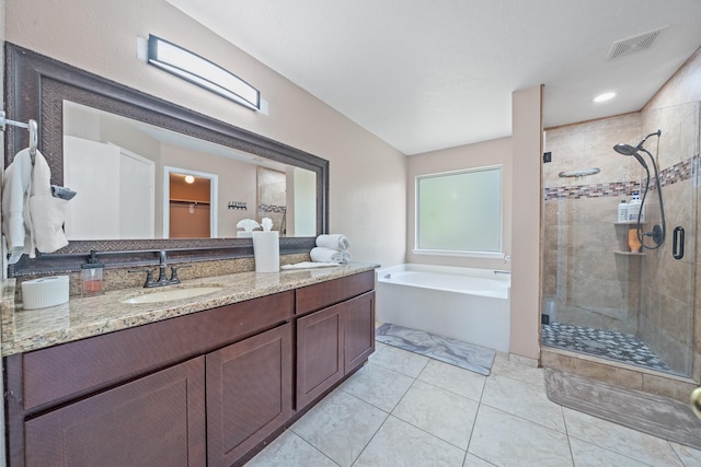 16815 Watering Oaks Ln, Houston, TX 77083 - bathroom featuring a stall shower, a bath, double vanity, tile patterned flooring, and a spacious closet