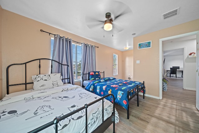 16815 Watering Oaks Ln, Houston, TX 77083 - bedroom with wood finished floors and a ceiling fan
