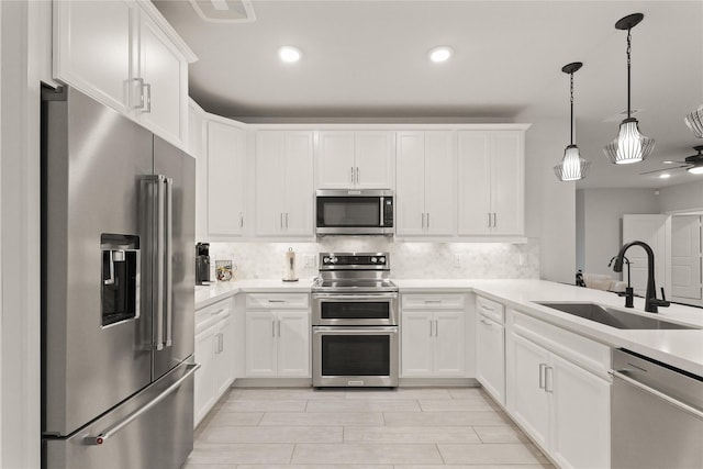 6804 Westview Dr Unit 1307, Houston, TX 77055 - kitchen featuring stainless steel appliances, decorative backsplash, light countertops, white cabinetry, and recessed lighting