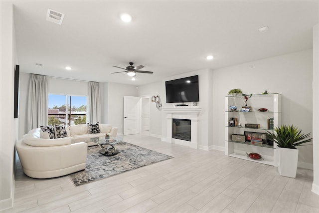 6804 Westview Dr Unit 1307, Houston, TX 77055 - living room featuring ceiling fan, light wood-style floors, a glass covered fireplace, and recessed lighting