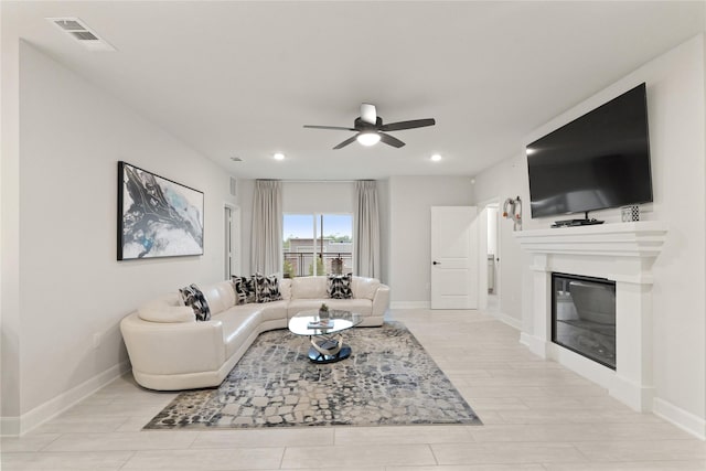 6804 Westview Dr Unit 1307, Houston, TX 77055 - living room featuring ceiling fan, a glass covered fireplace, recessed lighting, and light wood-style flooring