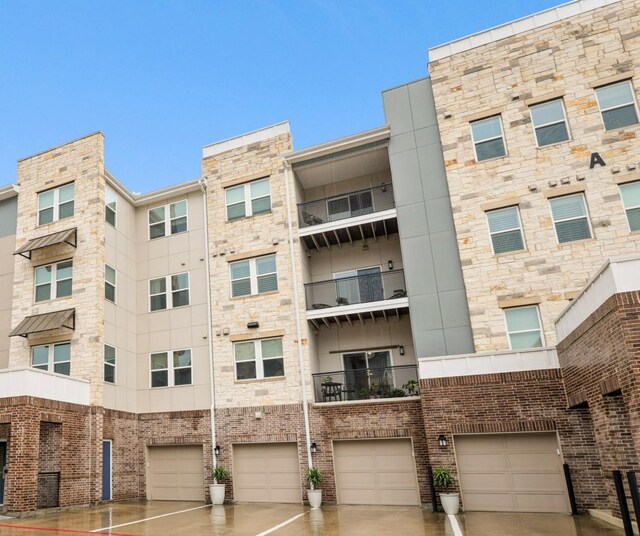 6804 Westview Dr Unit 1307, Houston, TX 77055 - view of apartment building / complex featuring driveway and a garage