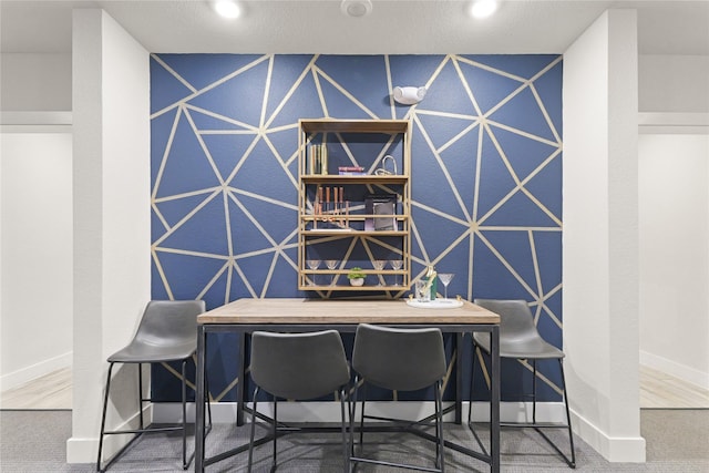 6804 Westview Dr Unit 1307, Houston, TX 77055 - dining space featuring carpet, an accent wall, and recessed lighting