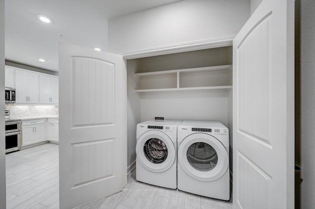 6804 Westview Dr Unit 1307, Houston, TX 77055 - washroom with independent washer and dryer, light wood-style flooring, and recessed lighting