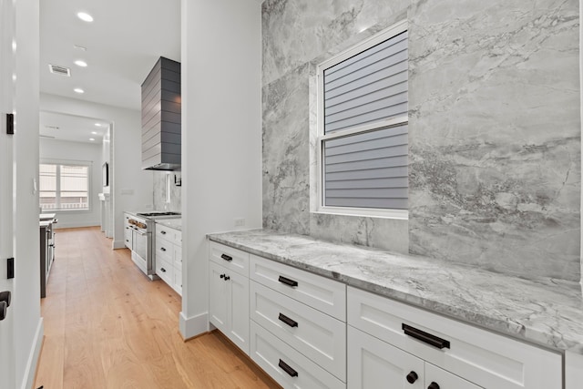 1313 Waverly St, Houston, TX 77008 - bar featuring range with two ovens, light wood-style floors, recessed lighting, and wall chimney exhaust hood
