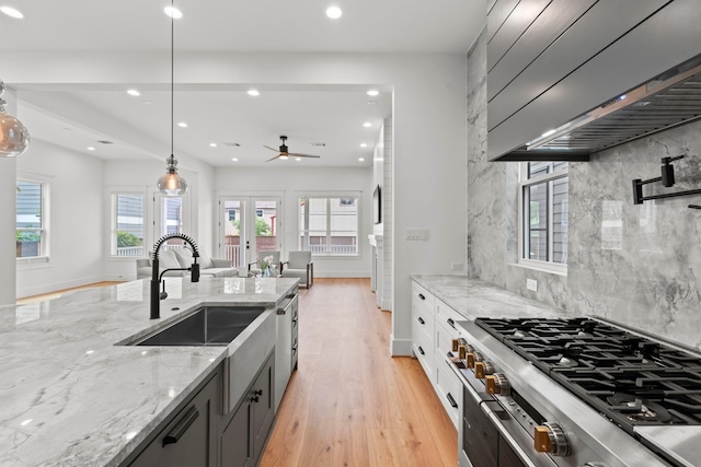 1313 Waverly St, Houston, TX 77008 - kitchen featuring cooktop, light wood-style floors, light stone counters, a ceiling fan, and recessed lighting