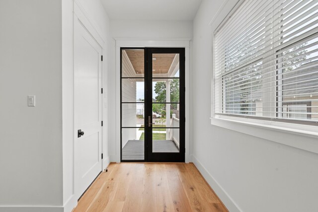 1313 Waverly St, Houston, TX 77008 - doorway to outside featuring light wood-type flooring and baseboards